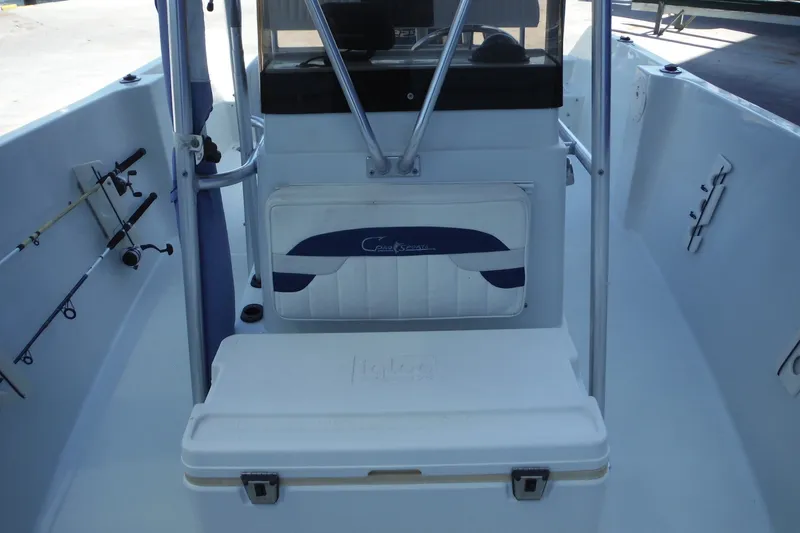 Slide: The Image of 1999 Pro Sports 2200 CC boat interior with fishing rods and cooler. - 24