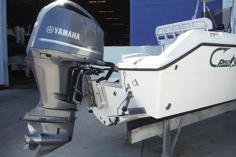 Slide: The Image of 1999 Pro Sports 2200 CC boat with Yamaha outboard motor in a storage facility. - 31