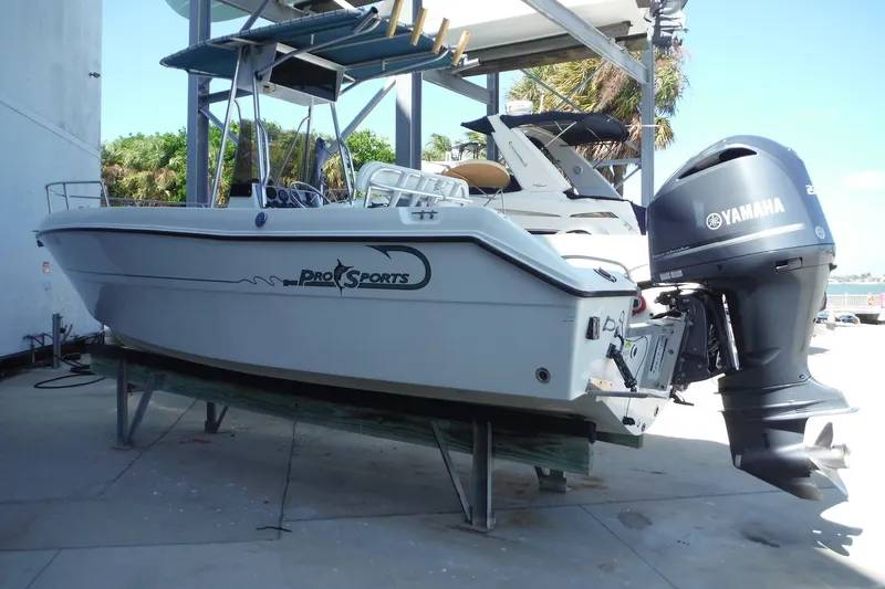 Slide: The Image of 1999 Pro Sports 2200 CC boat with Yamaha outboard motor on a stand. - 1