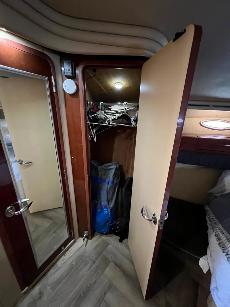 Slide: The Image of Interior of 2002 Sea Ray 560 Sedan Bridge showing closet and bedroom area. - 44