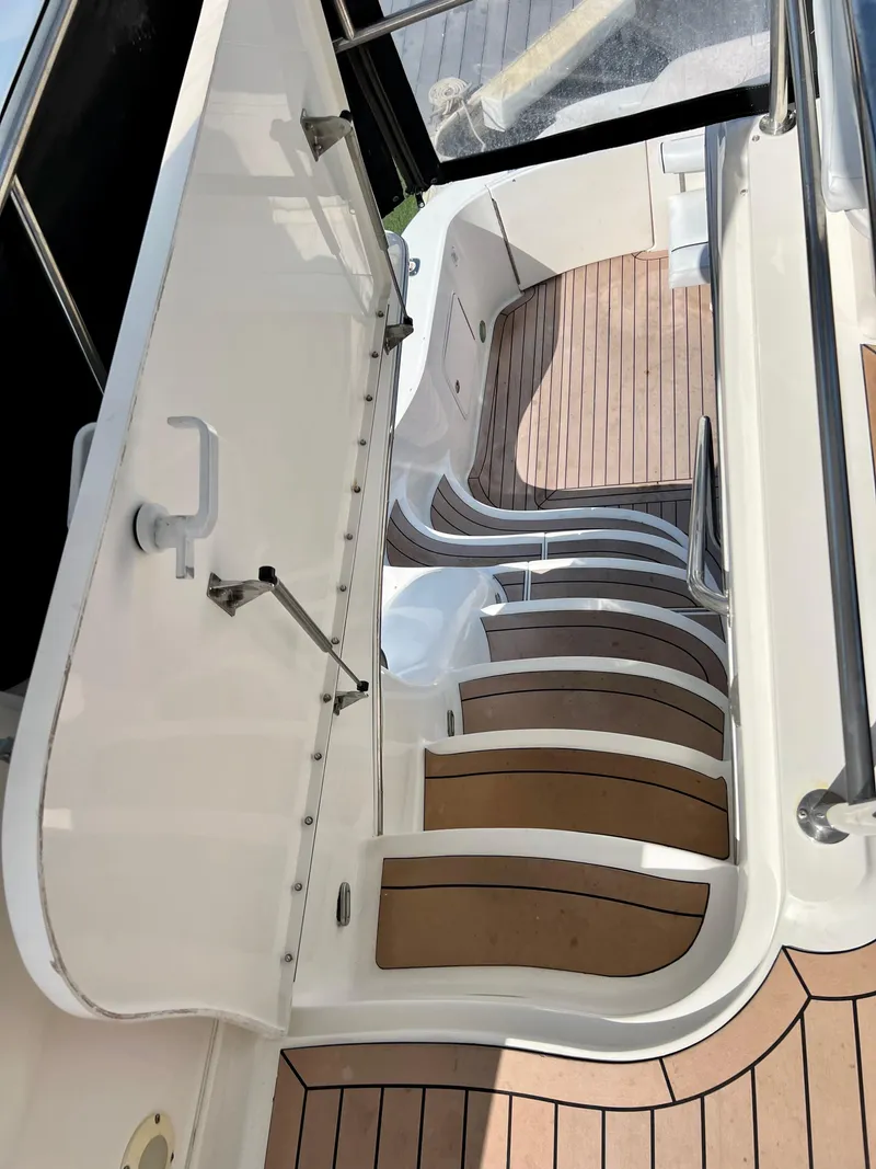 Slide: The Image of Staircase on 2002 Sea Ray 560 Sedan Bridge yacht with teak flooring. - 28