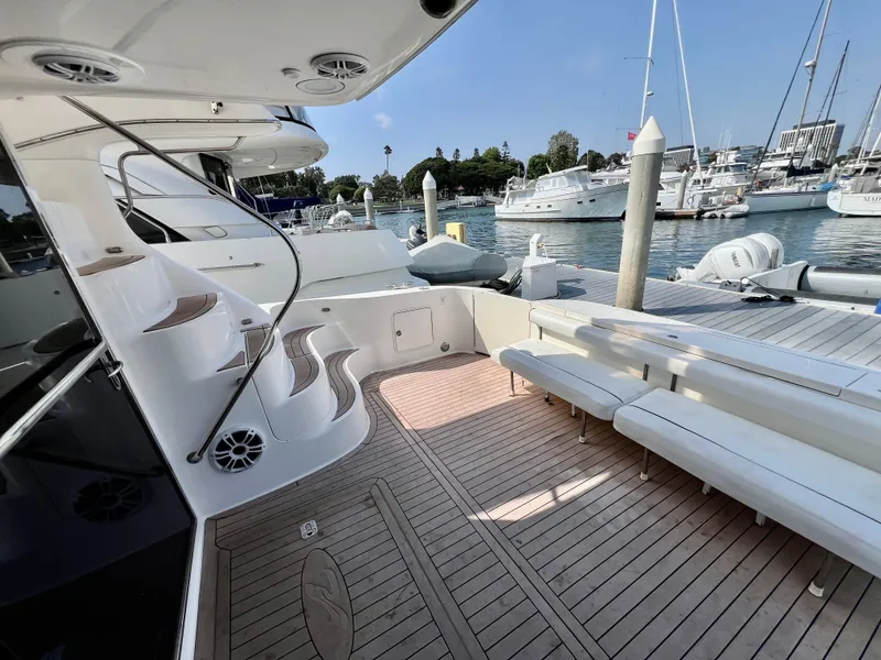 Slide: The Image of Luxurious 2002 Sea Ray 560 Sedan Bridge yacht docked, featuring spacious deck and elegant seating. - 18
