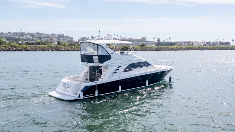 Slide: The Image of 2002 Sea Ray 560 Sedan Bridge yacht cruising on a sunny day. - 2