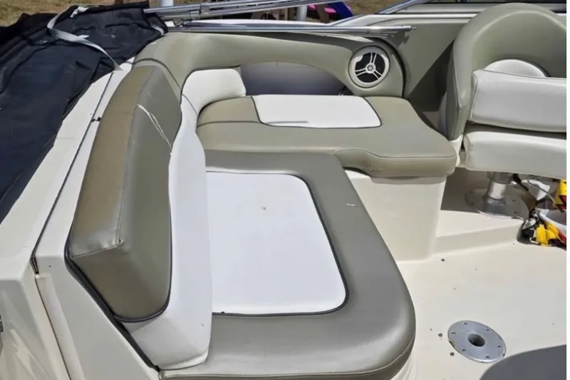 Slide: The Image of 2006 Sea Ray 220 Sundeck interior with cushioned seating and speaker detail. - 5
