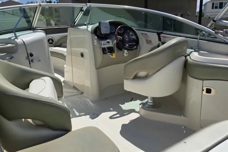 Slide: The Image of Interior of a 2006 Sea Ray 220 Sundeck boat with steering console and seating. - 3