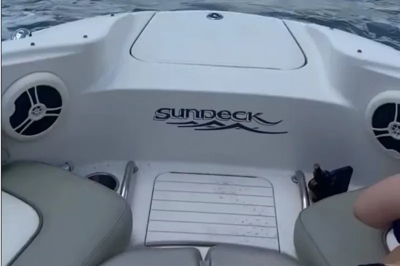 Slide: The Image of 2006 Sea Ray 220 Sundeck boat interior with seating and speakers. - 11