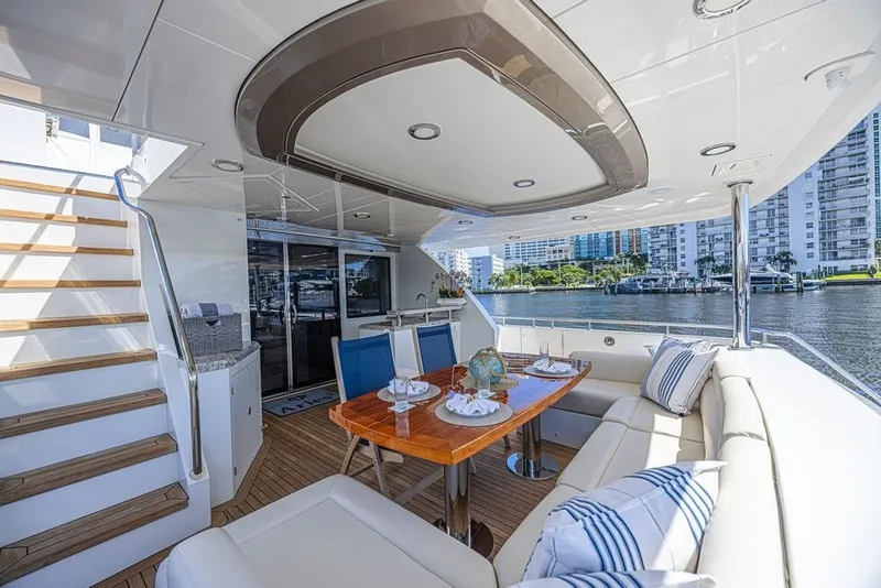 Slide: The Image of Luxurious 2018 Ocean Alexander 85 E yacht deck with elegant dining area and waterfront view. - 7