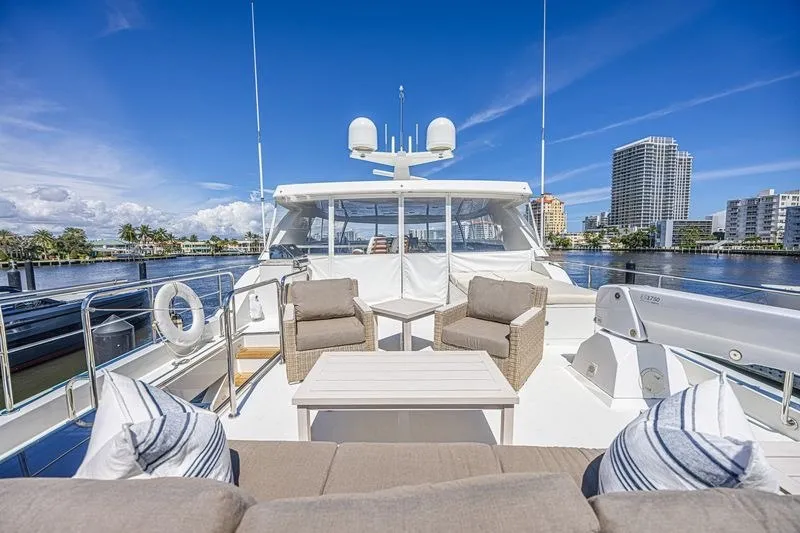 Slide: The Image of Luxurious 2018 Ocean Alexander 85 E yacht deck with seating, city skyline, and waterfront view. - 16
