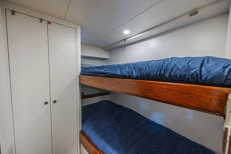 Slide: The Image of Bunk beds in 2018 Ocean Alexander 85 E yacht cabin with blue bedding. - 43
