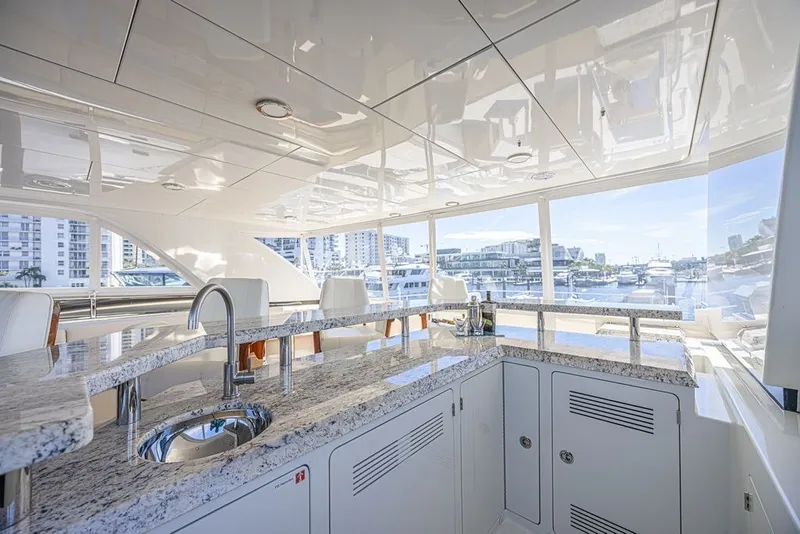 Slide: The Image of Luxurious interior of 2018 Ocean Alexander 85 E yacht with granite countertops and marina view. - 13