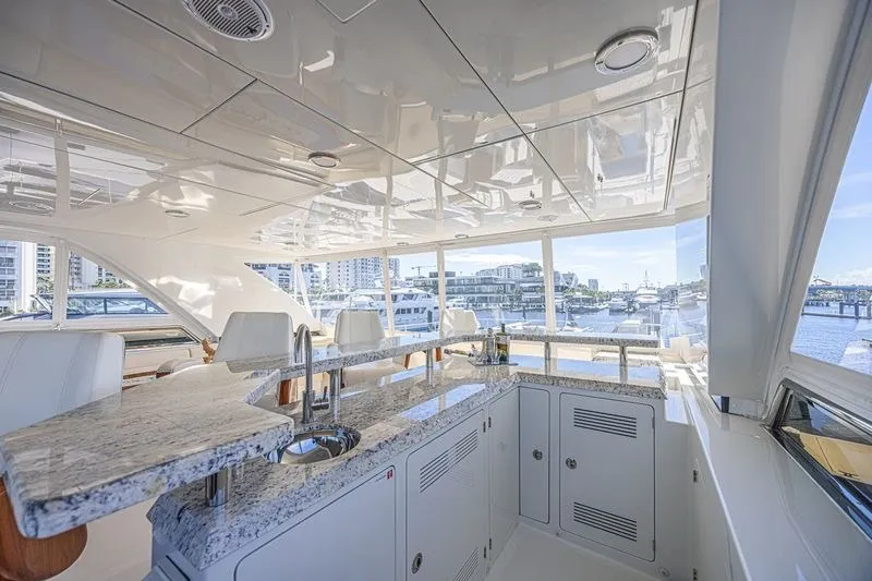 Slide: The Image of Luxurious interior of 2018 Ocean Alexander 85 E yacht with granite countertops and marina view. - 11