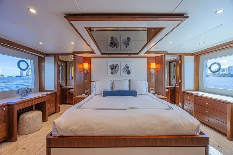 Slide: The Image of Luxurious bedroom interior on 2018 Ocean Alexander 85 E yacht, featuring elegant wood finishes. - 26