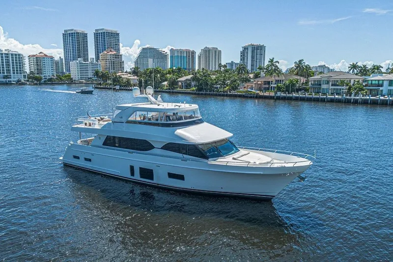Slide: The Image of Luxury 2018 Ocean Alexander 85 E yacht cruising near waterfront cityscape. - 2