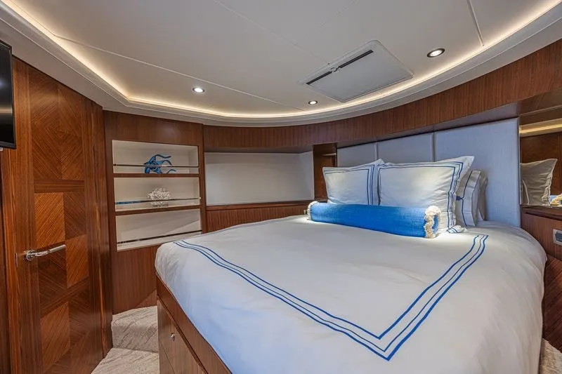 Slide: The Image of Luxurious bedroom interior on 2018 Ocean Alexander 85 E yacht, featuring elegant wood paneling. - 34