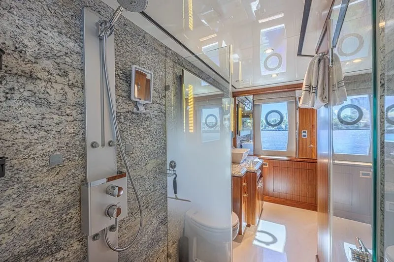 Slide: The Image of Luxurious bathroom on 2018 Ocean Alexander 85 E yacht with granite shower and elegant wood accents. - 33