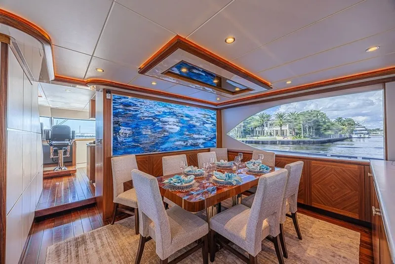 Slide: The Image of Luxurious dining area on 2018 Ocean Alexander 85 E yacht with elegant decor and scenic window view. - 23