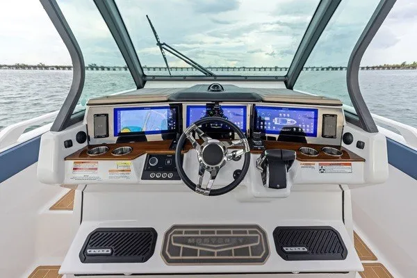 Slide: The Image of 2027 Monterey Elite 34 OB boat dashboard with advanced navigation screens and steering wheel. - 6
