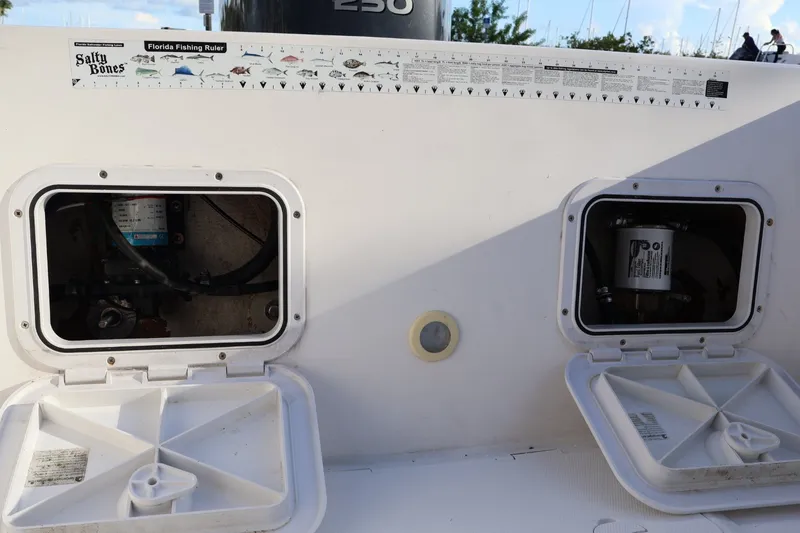 Slide: The Image of 1989 Mako 231 Center Console boat with open storage compartments and fishing ruler. - 14