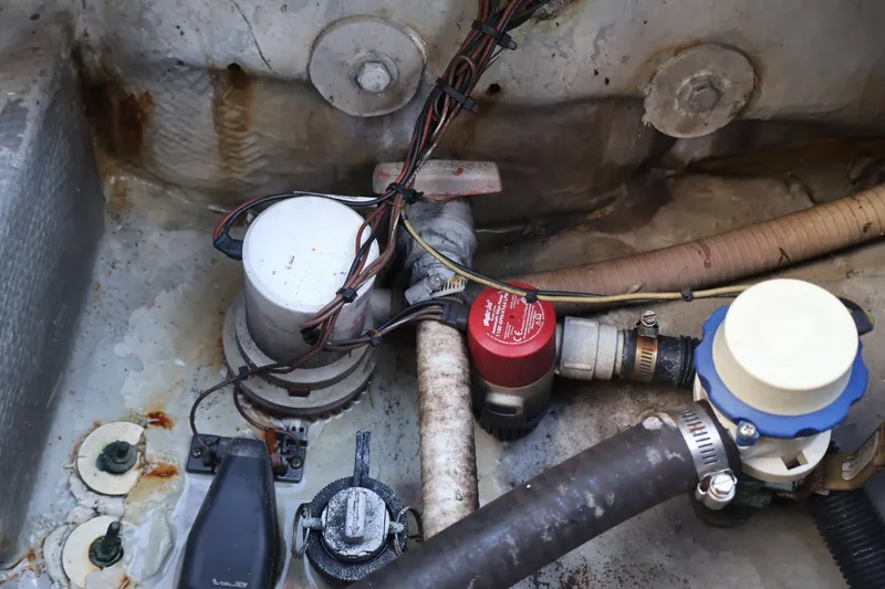 Slide: The Image of Bilge area of a 1989 Mako 231 Center Console boat with pumps and wiring. - 16