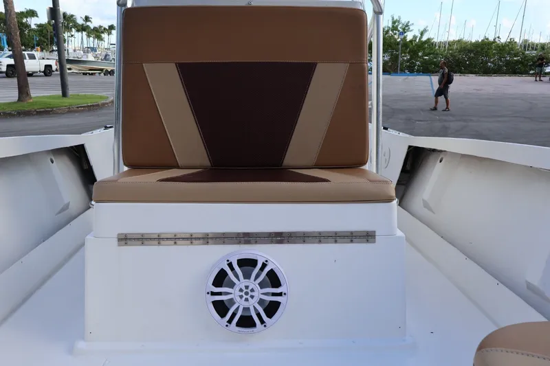 Slide: The Image of 1989 Mako 231 Center Console boat interior with brown seating and speaker. - 17