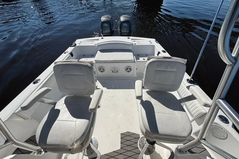 Slide: The Image of 2008 Angler 220WA boat interior with seating and dual outboard motors on water. - 9