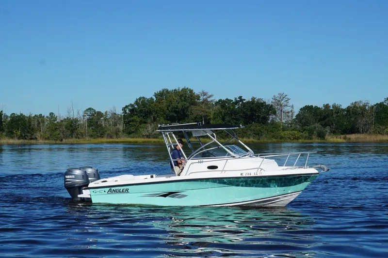 Slide: The Image of 2008 Angler 220WA boat on calm water with Yamaha outboard motor. - 6