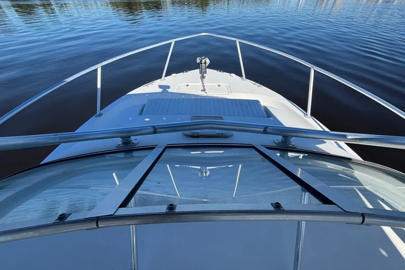 Slide: The Image of Bow view of 2008 Angler 220WA boat on calm water. - 11