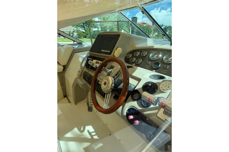 Slide: The Image of Helm of 2004 Cruisers Yachts 340 Express with steering wheel and control panel. - 7