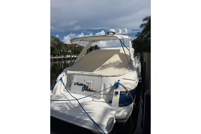 Slide: The Image of 2004 Cruisers Yachts 340 Express docked, featuring covered seating and nautical equipment. - 1