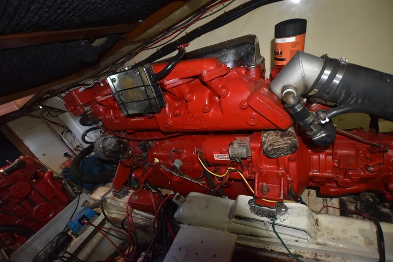 Slide: The Image of Engine room of 1985 Albin 43 Trawler with red machinery and wiring. - 25