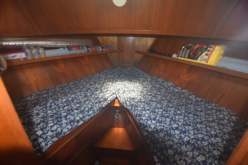 Slide: The Image of Cozy cabin interior of 1985 Albin 43 Trawler with floral bedding and wooden shelves. - 12