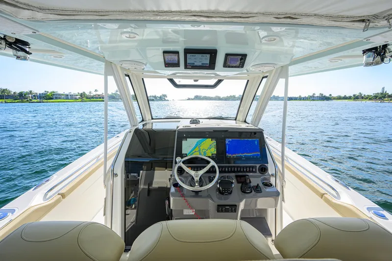 Slide: The Image of 2020 Pursuit S 368 Sport boat interior with advanced navigation system on open water. - 15