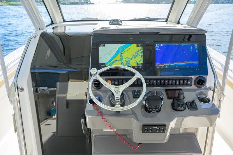 Slide: The Image of 2020 Pursuit S 368 Sport boat helm with advanced navigation displays and controls. - 20
