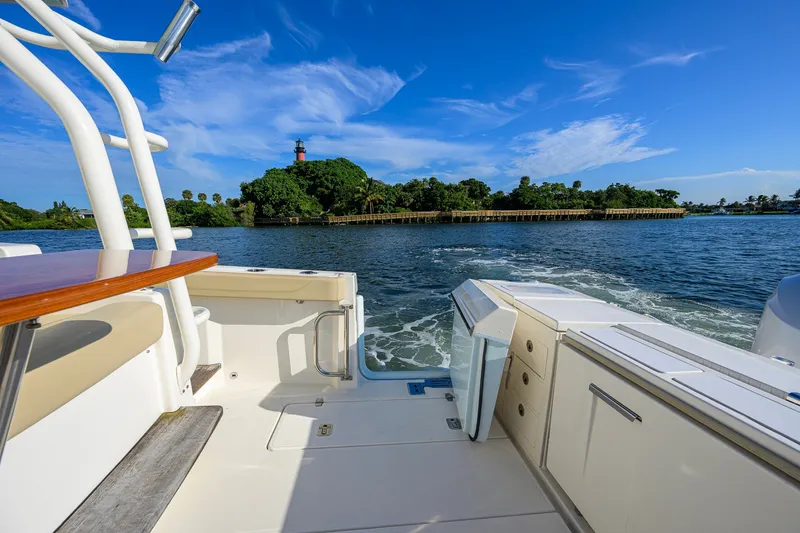 Slide: The Image of 2020 Pursuit S 368 Sport boat on water, scenic island view in background. - 25