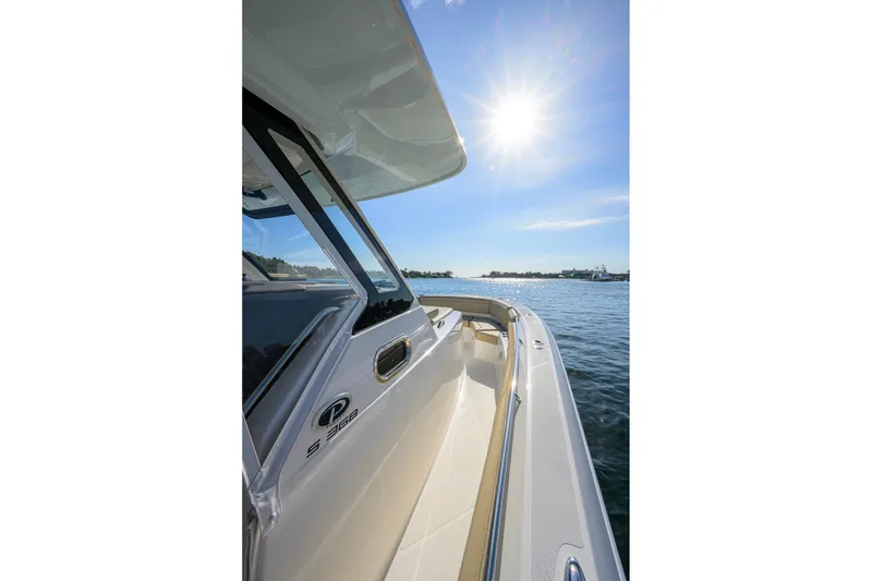 Slide: The Image of 2020 Pursuit S 368 Sport boat on water under bright sun. - 14