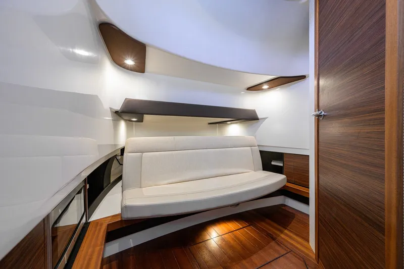 Slide: The Image of 2020 Pursuit S 368 Sport cabin interior with modern seating and wooden accents. - 31
