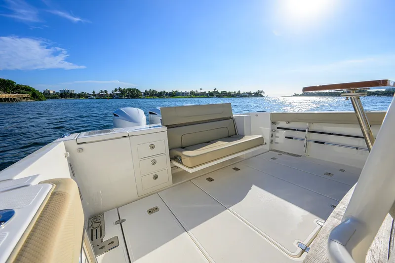 Slide: The Image of 2020 Pursuit S 368 Sport boat interior with seating, ocean view, and sunny sky. - 24