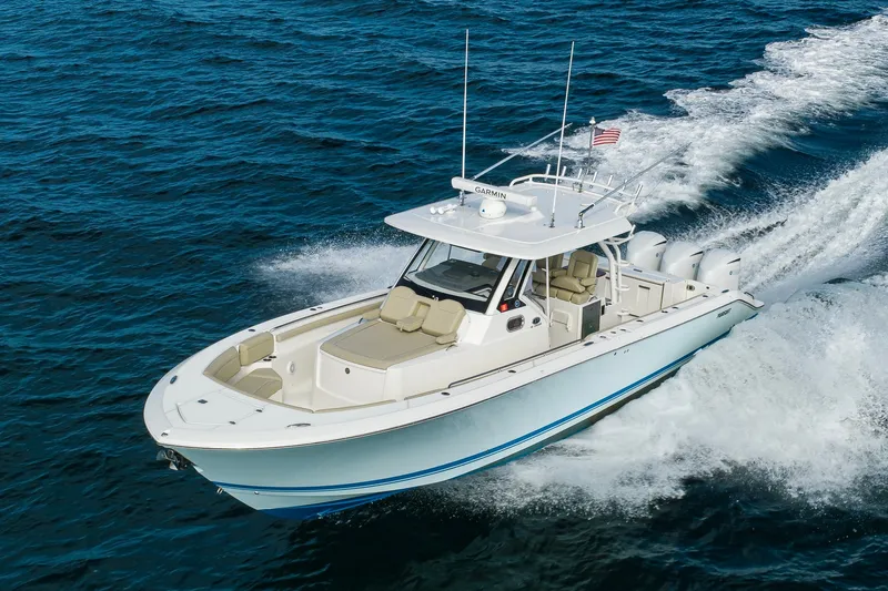 Slide: The Image of 2020 Pursuit S 368 Sport boat cruising on open water. - 44