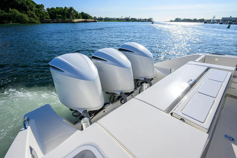 Slide: The Image of 2020 Pursuit S 368 Sport boat with triple outboard engines on a sunny day. - 34