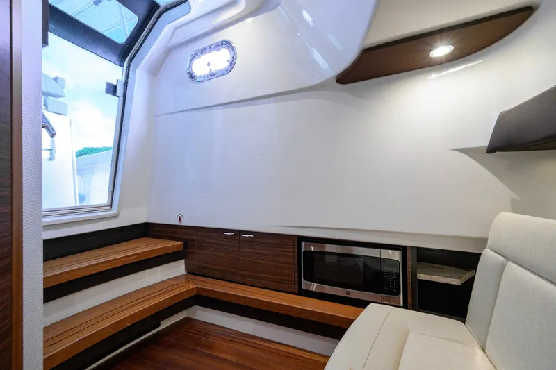 Slide: The Image of Interior of 2020 Pursuit S 368 Sport boat with seating and microwave. - 32