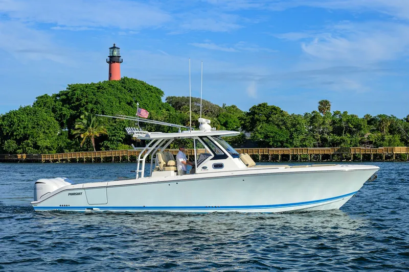 The Image of 2020 Pursuit S 368 Sport boat cruising near a lighthouse and lush greenery. - 0