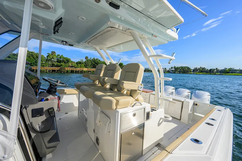 Slide: The Image of 2020 Pursuit S 368 Sport boat interior with helm seats and ocean view. - 22