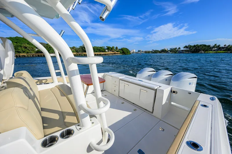 Slide: The Image of 2020 Pursuit S 368 Sport boat with triple engines on a sunny day. - 16