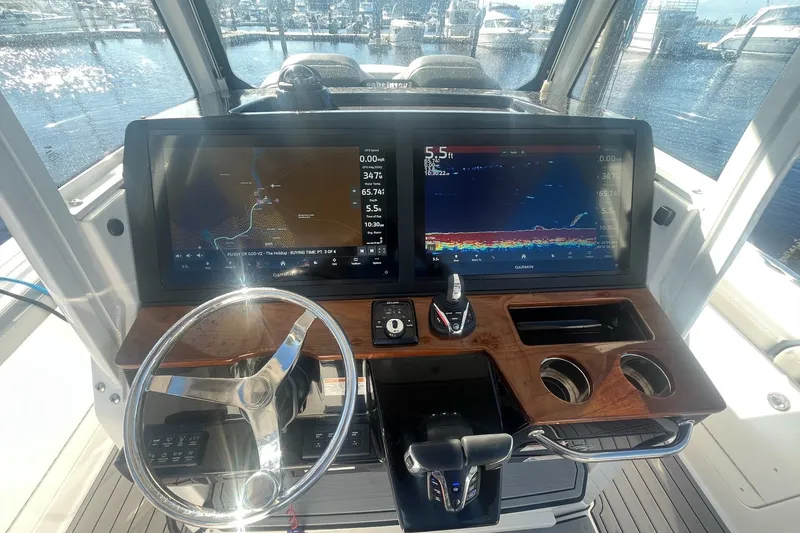 Slide: The Image of Helm of 2025 Everglades 315 Center Console with dual Garmin displays and steering wheel. - 7