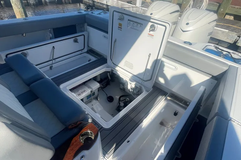 Slide: The Image of 2025 Everglades 315 Center Console boat interior with open storage compartments. - 12