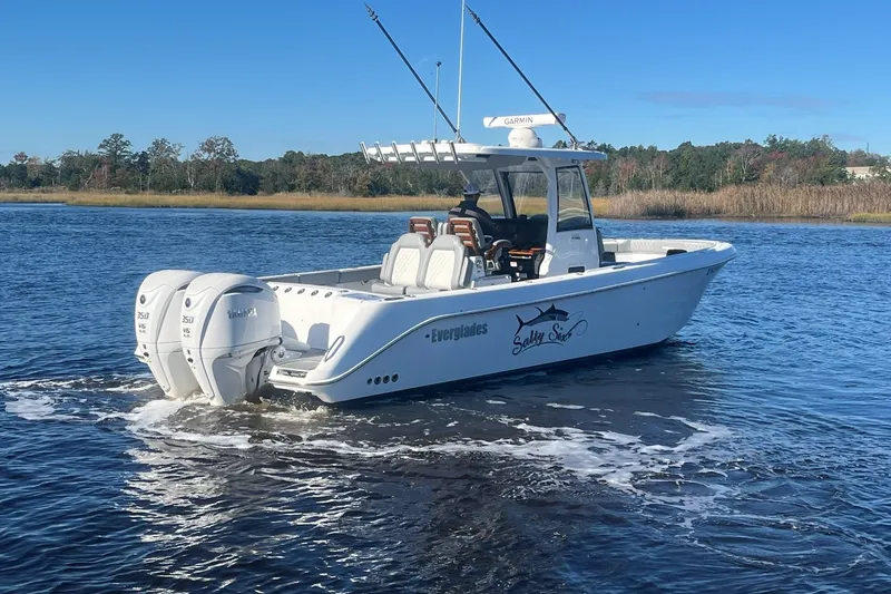 Slide: The Image of 2025 Everglades 315 Center Console boat on water, featuring twin Yamaha engines. - 2