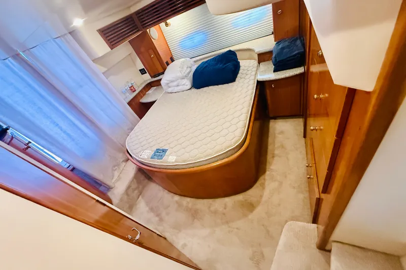 Slide: The Image of Luxurious bedroom interior of 2001 Carver 444 Cockpit Motor Yacht with cozy bed and wooden cabinetry. - 22