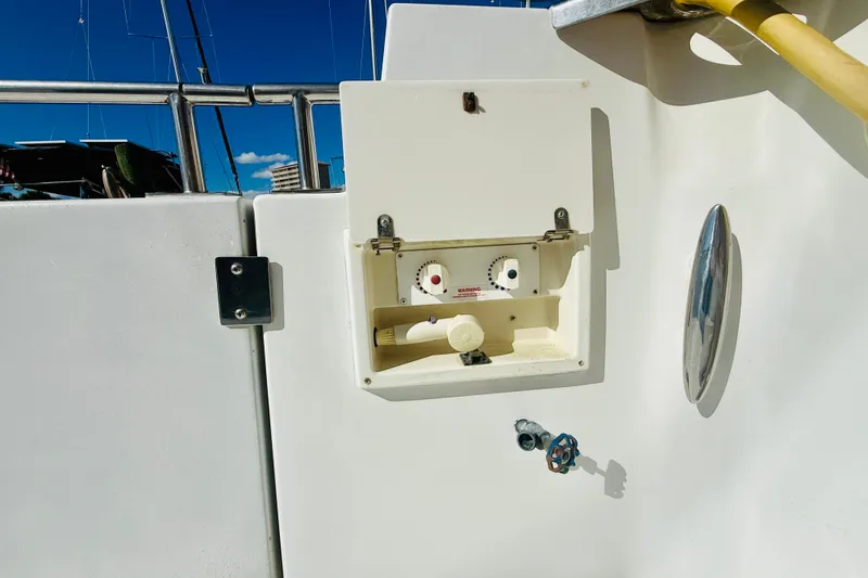 Slide: The Image of 2001 Carver 444 Cockpit Motor Yacht water hookup panel with blue sky background. - 30