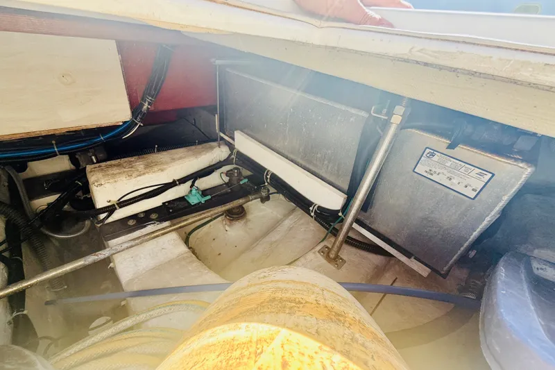 Slide: The Image of Engine compartment of a 2001 Carver 444 Cockpit Motor Yacht, showing mechanical components. - 26