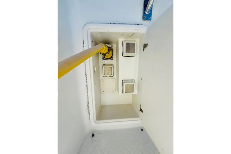 Slide: The Image of Storage compartment with yellow hose in 2001 Carver 444 Cockpit Motor Yacht. - 29